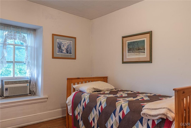 bedroom featuring cooling unit and hardwood / wood-style floors