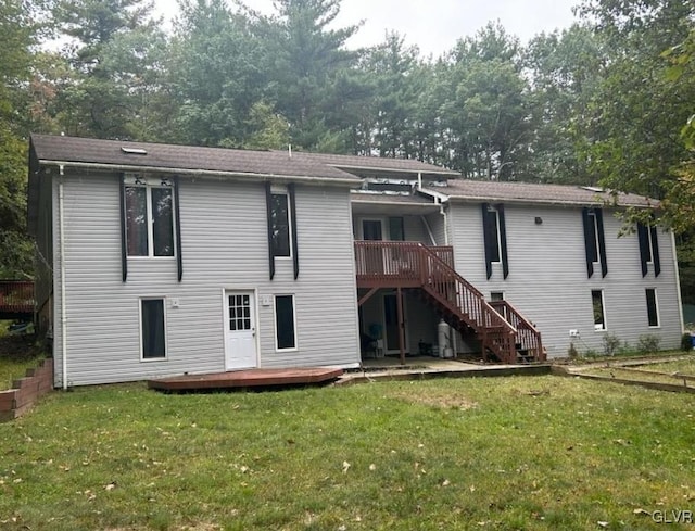 back of property featuring a yard and a wooden deck