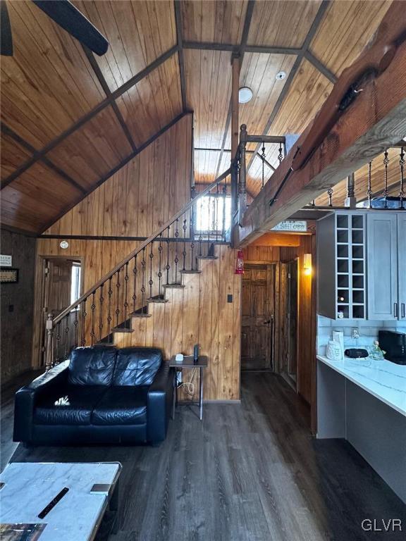 unfurnished living room featuring dark hardwood / wood-style floors, wood ceiling, and wood walls