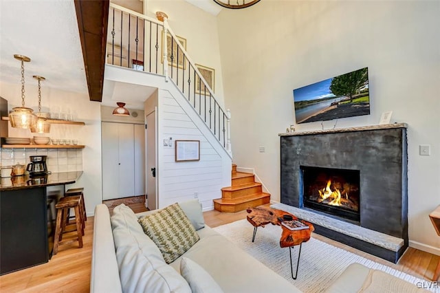 living room with beam ceiling and light hardwood / wood-style floors