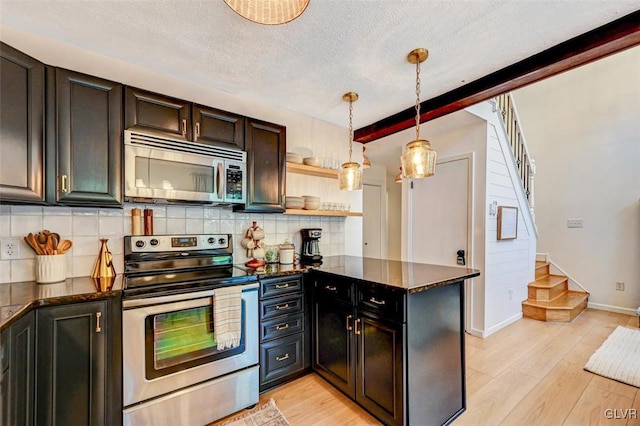 kitchen with kitchen peninsula, tasteful backsplash, light hardwood / wood-style flooring, stainless steel appliances, and dark stone counters