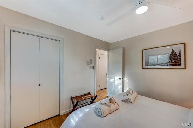 bedroom featuring light wood-type flooring, a closet, and ceiling fan