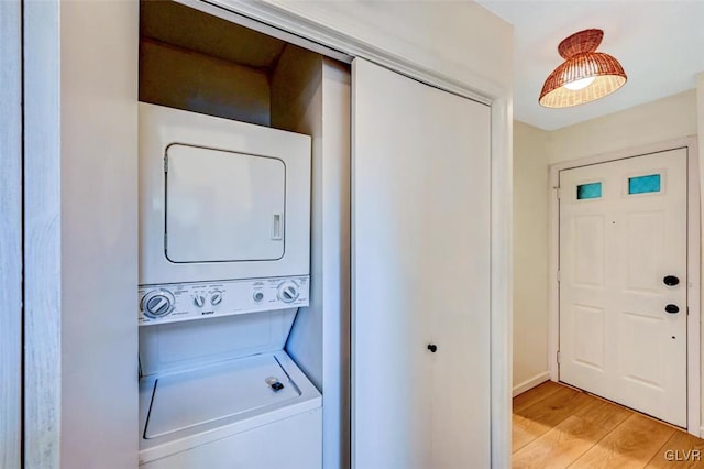 washroom featuring light wood-type flooring and stacked washer and dryer