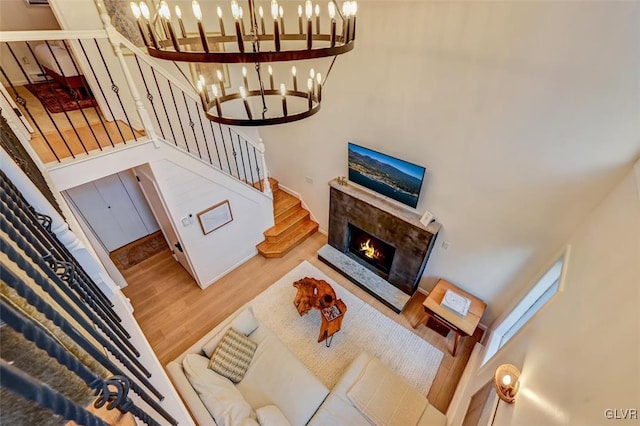 living room featuring a towering ceiling and hardwood / wood-style floors