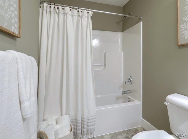 bathroom featuring shower / bath combination with curtain and toilet