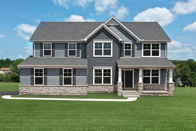 craftsman house with covered porch and a front yard