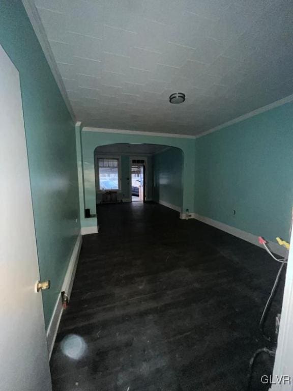 interior space featuring ornamental molding and dark hardwood / wood-style floors