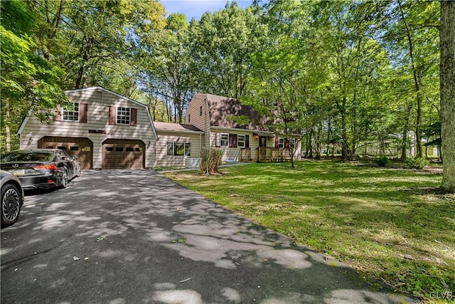 view of front of property with a front lawn and a garage