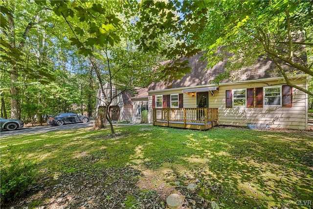 view of front of house with a front yard and a deck