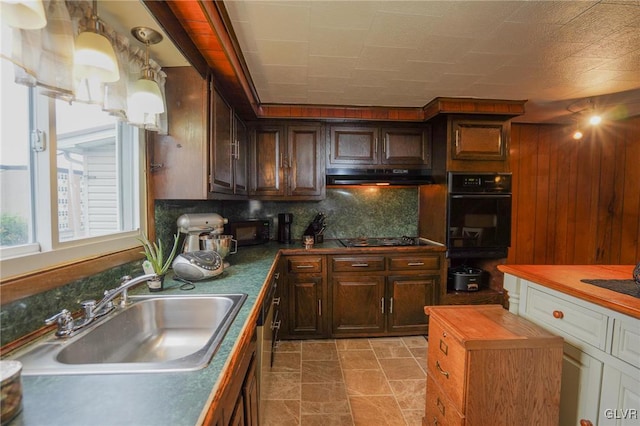 kitchen featuring black appliances, decorative backsplash, sink, and dark brown cabinetry