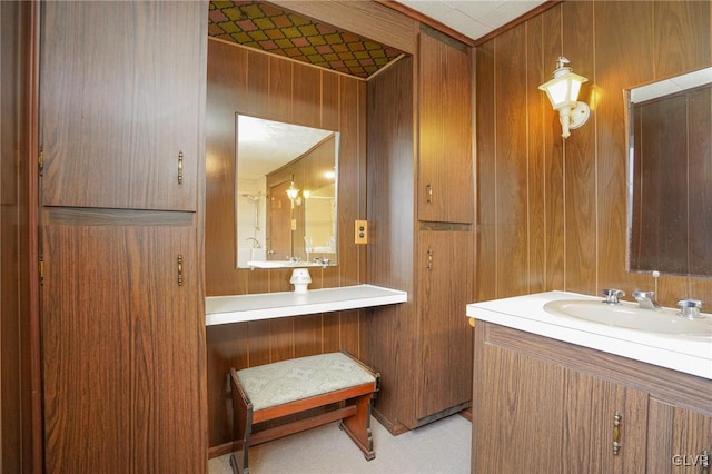 bathroom with vanity and wood walls