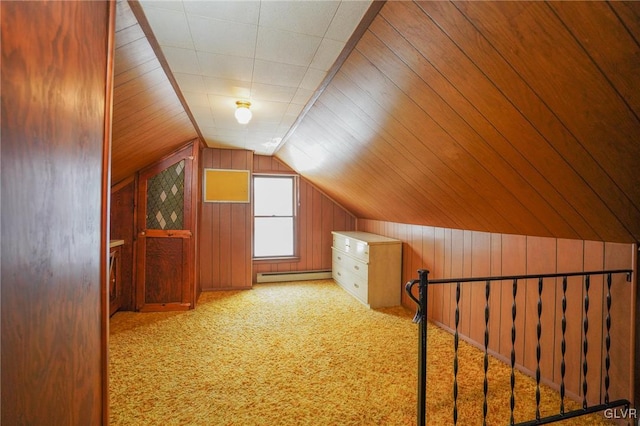 bonus room featuring light carpet, lofted ceiling, wood walls, and a baseboard heating unit