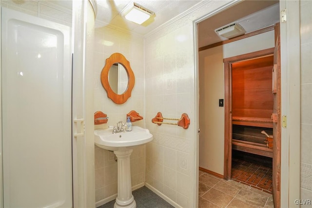 bathroom featuring tile walls, ornamental molding, and tile patterned floors