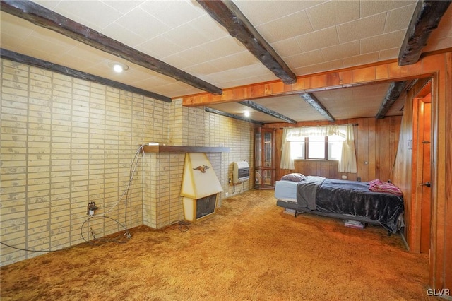 bedroom featuring carpet floors, wood walls, beamed ceiling, and heating unit