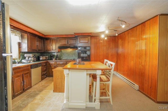 kitchen with backsplash, a kitchen island, dishwasher, wooden counters, and wooden walls