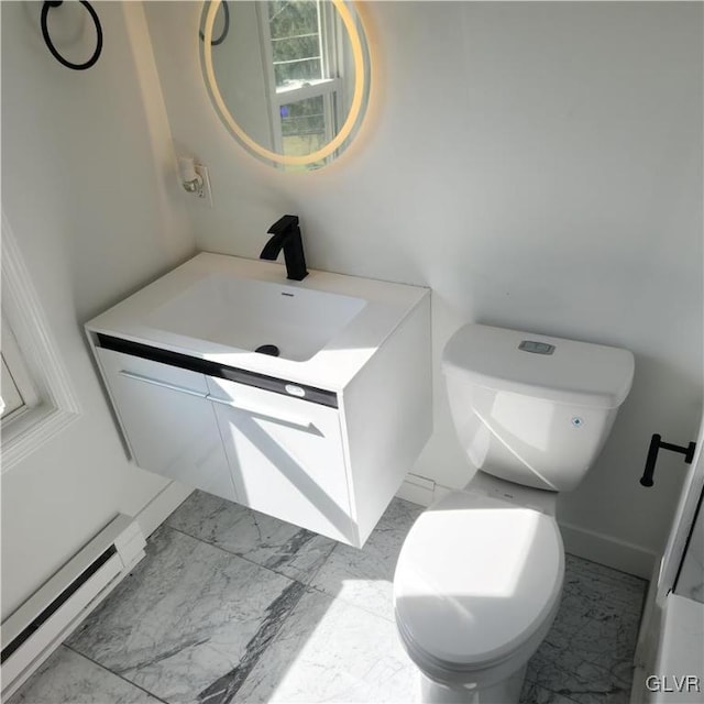 bathroom with toilet, vanity, and baseboard heating