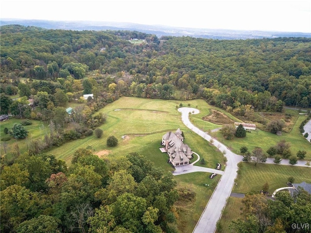 bird's eye view featuring a wooded view