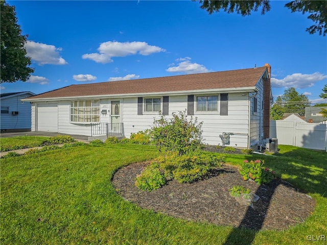 view of front of property with a garage and a front yard