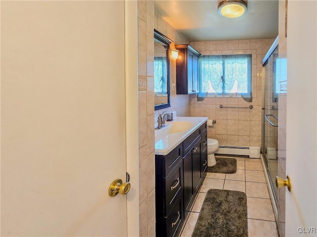 bathroom featuring vanity, a shower with shower door, a baseboard radiator, tile walls, and toilet