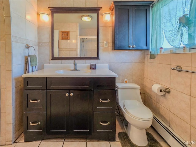 bathroom featuring tile patterned floors, vanity, toilet, and a baseboard heating unit