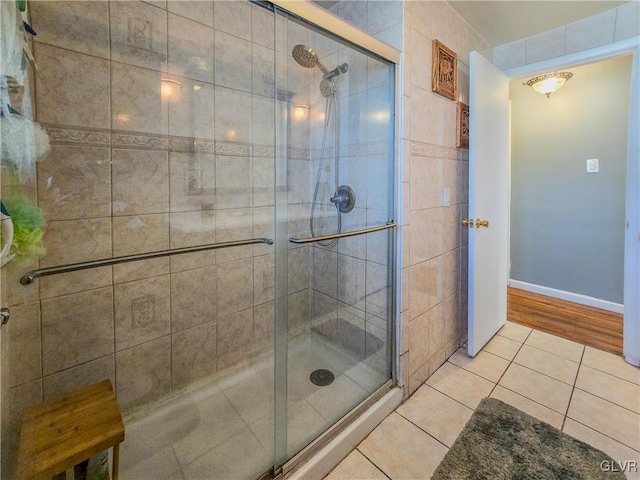 bathroom with tile patterned flooring and a shower with door