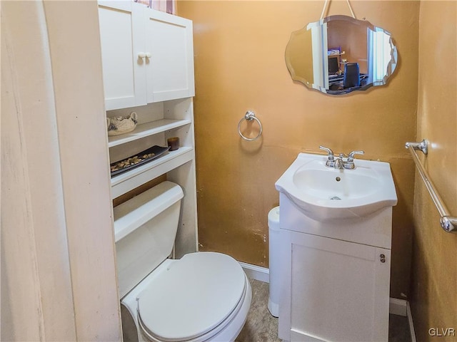 bathroom featuring toilet and vanity