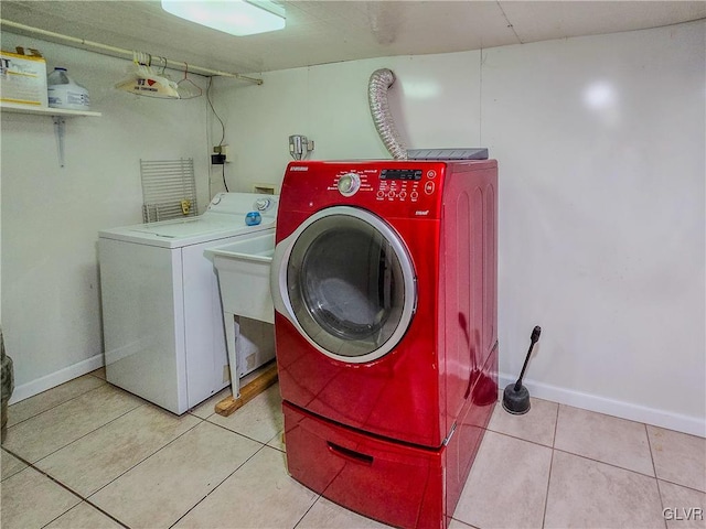 laundry room with separate washer and dryer and light tile patterned flooring