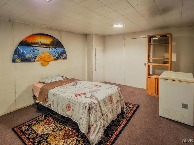 carpeted bedroom with refrigerator