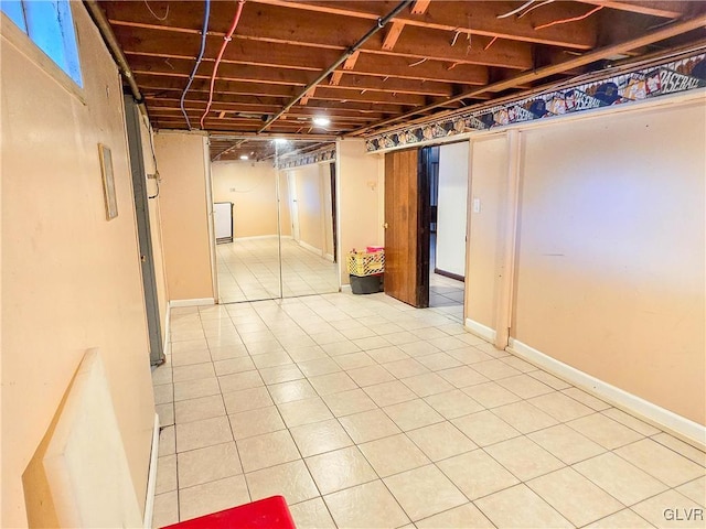 basement featuring light tile patterned floors