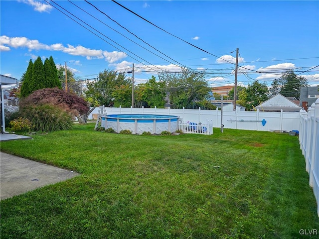 view of yard with a fenced in pool