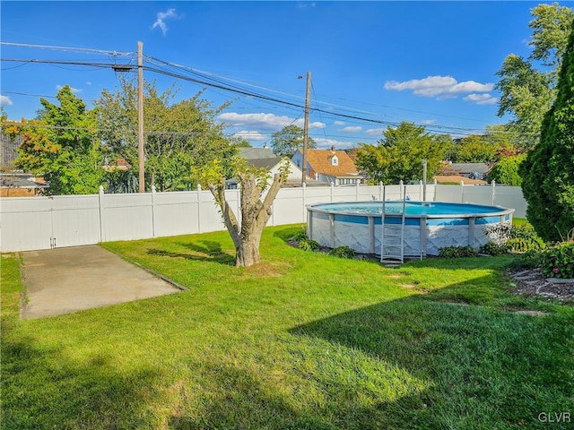 view of yard featuring a fenced in pool and a patio