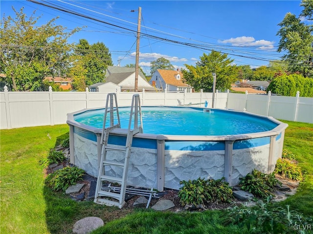 view of pool featuring a lawn