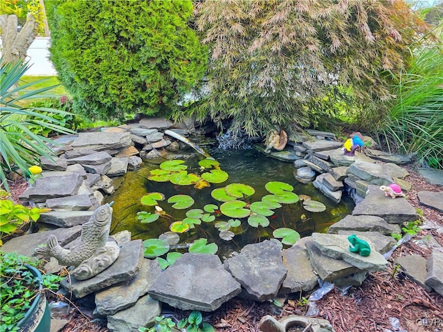 exterior details featuring a garden pond