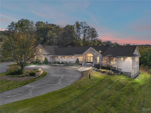 ranch-style house featuring a lawn