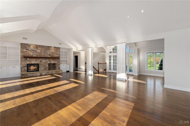 unfurnished living room featuring vaulted ceiling, a fireplace, built in features, and dark hardwood / wood-style flooring