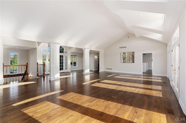 unfurnished living room with dark wood-type flooring and high vaulted ceiling