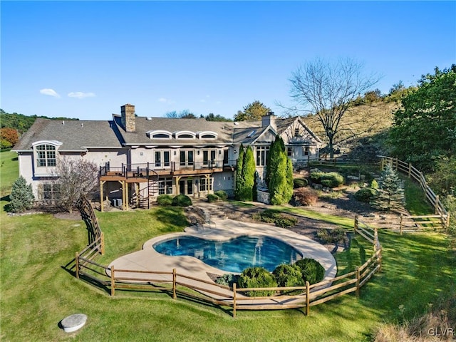 back of house with a yard, a swimming pool side deck, and a patio