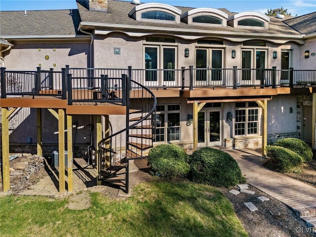 back of house with a wooden deck and a patio area