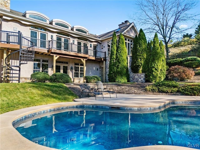 view of pool with a yard and a patio area