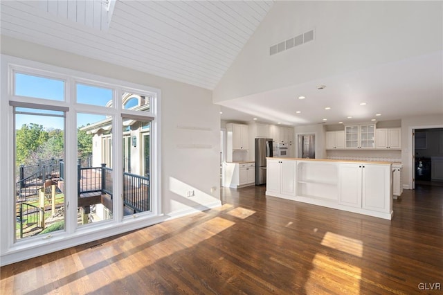 unfurnished living room with wooden ceiling, dark hardwood / wood-style floors, and high vaulted ceiling