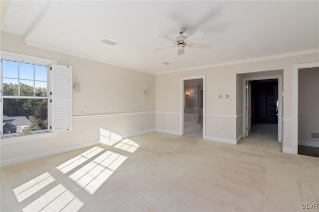 carpeted spare room featuring crown molding and ceiling fan