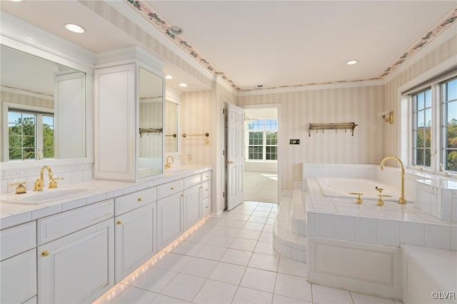 bathroom with crown molding, tile patterned floors, a relaxing tiled tub, and vanity