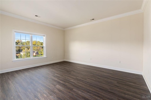 empty room featuring ornamental molding and dark hardwood / wood-style flooring