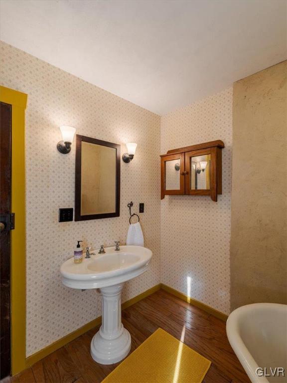 bathroom featuring a bathing tub and wood-type flooring