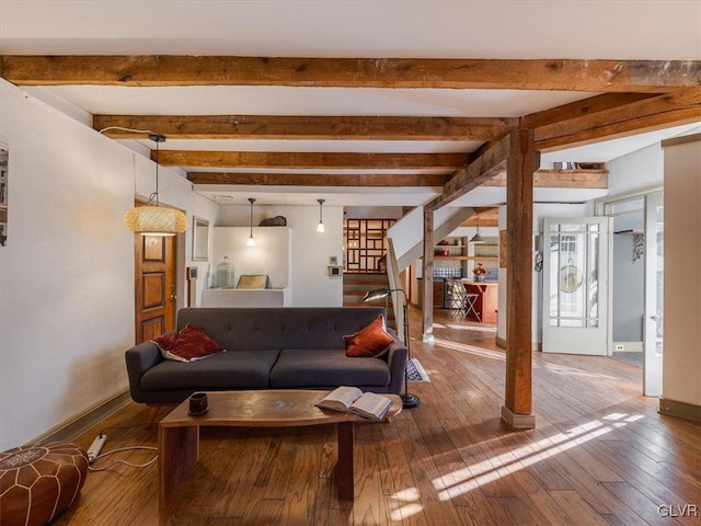 living room featuring beam ceiling and wood-type flooring