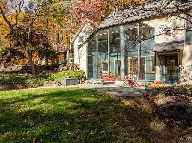 view of yard with a patio area and a sunroom