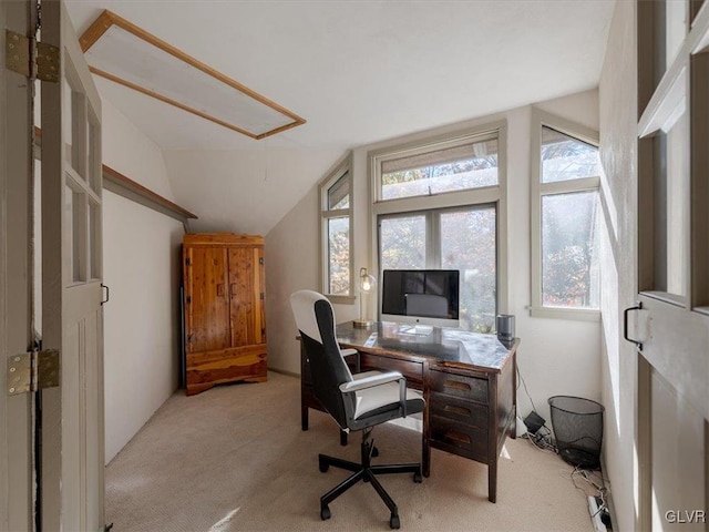 office area featuring light colored carpet and lofted ceiling