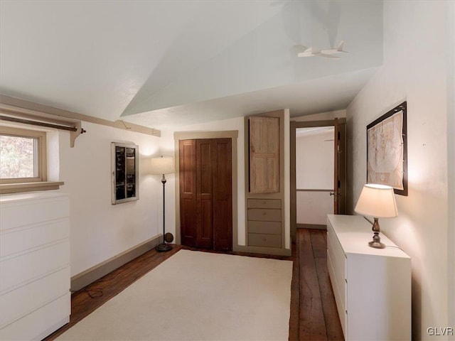 unfurnished bedroom featuring dark hardwood / wood-style floors and vaulted ceiling