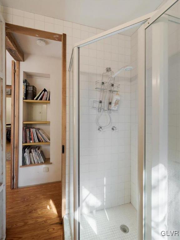 bathroom featuring walk in shower and hardwood / wood-style flooring