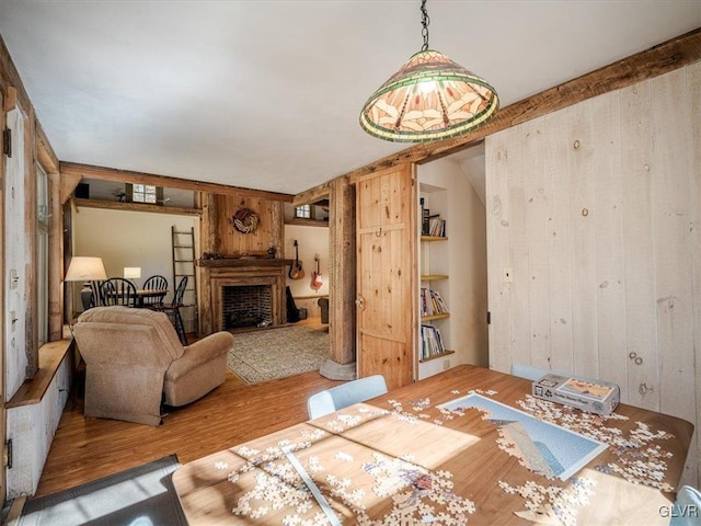 dining area with wood walls and hardwood / wood-style flooring